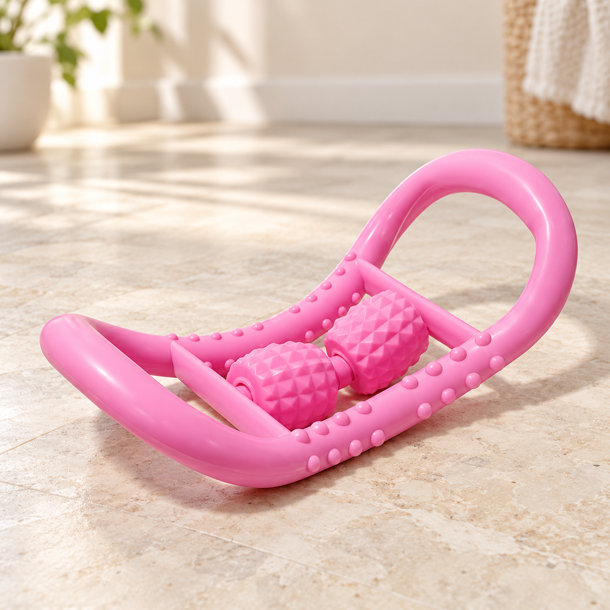 SC-84075 pink massage ring with two central textured rollers on a pale stone floor